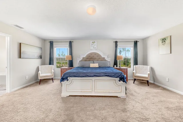 a view of swimming pool with outdoor seating and house in the background