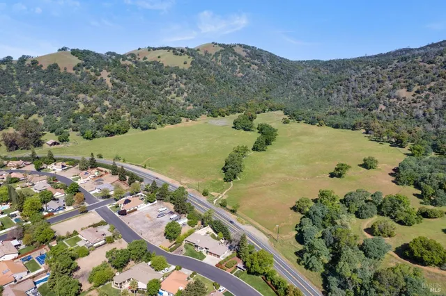 an aerial view of residential houses with outdoor space