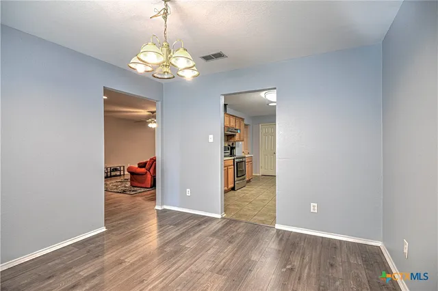 a view of a room with wooden floor gym equipment and wooden floor