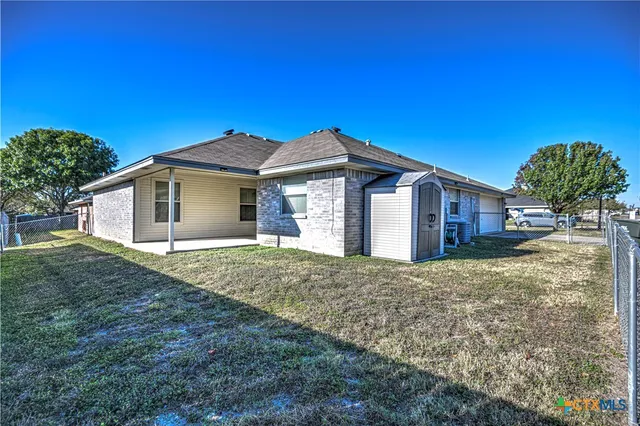 a large house with a big yard and large tree
