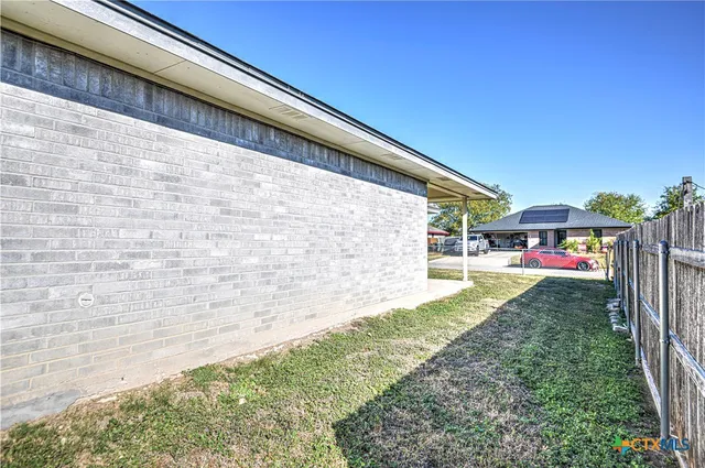 a view of house with backyard