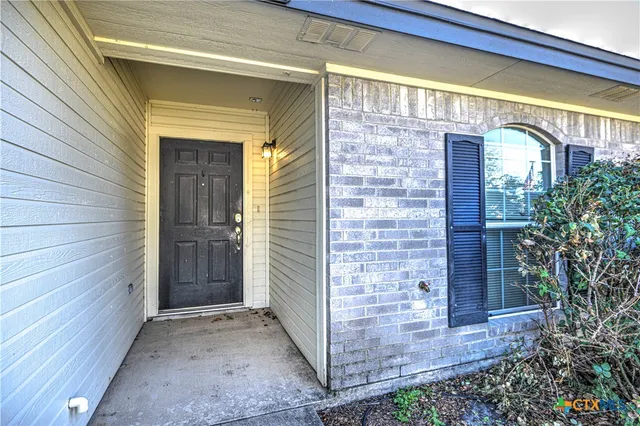 a view of front door of house with wooden door