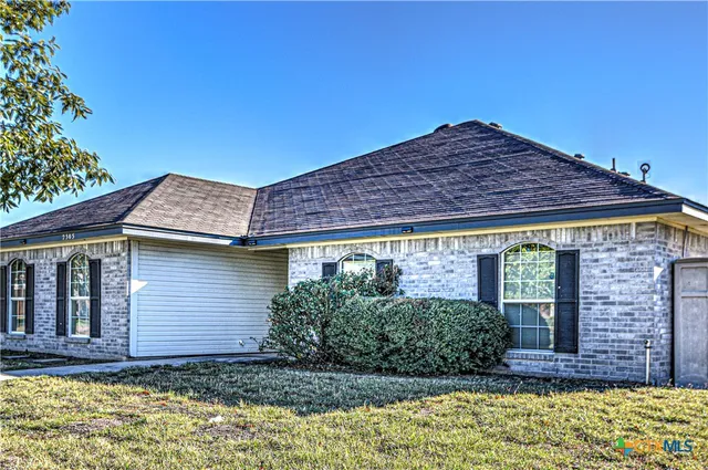 a view of a house with potted plants