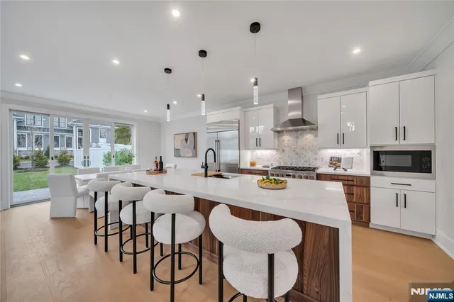 a large kitchen with a table and chairs