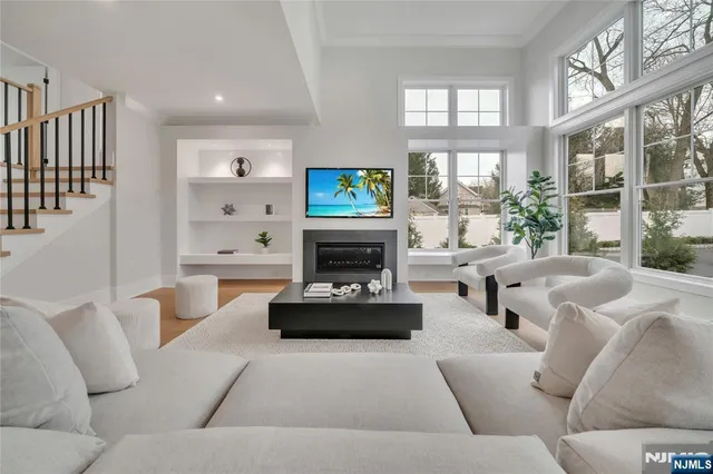 a living room with furniture a fireplace and a flat screen tv