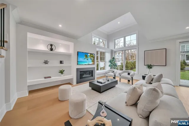 a living room with furniture fireplace and a large window