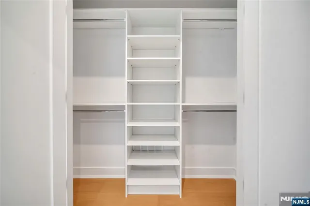 a view of walk in closet with empty racks