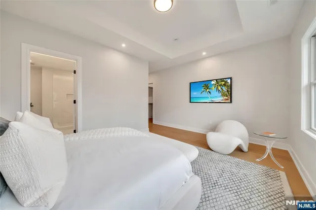 a bedroom with a bed and a painting on the wall