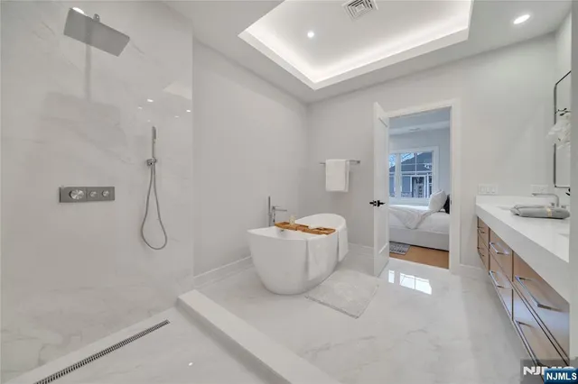 a bathroom with a granite countertop sink a toilet and shower