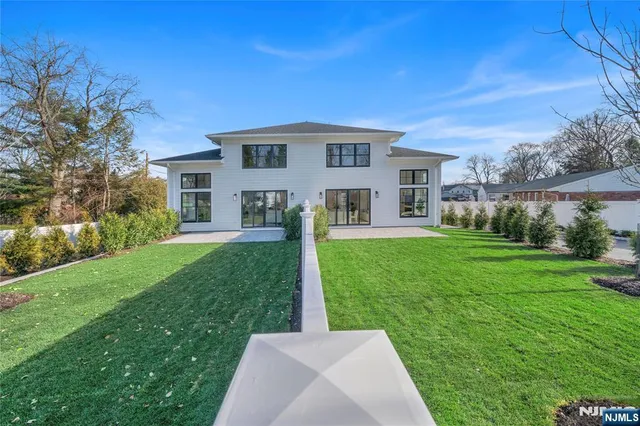 a front view of house with a garden