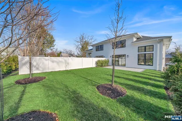 a view of a house with a backyard and a garden