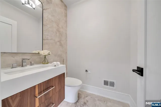 a bathroom with a sink toilet and vanity