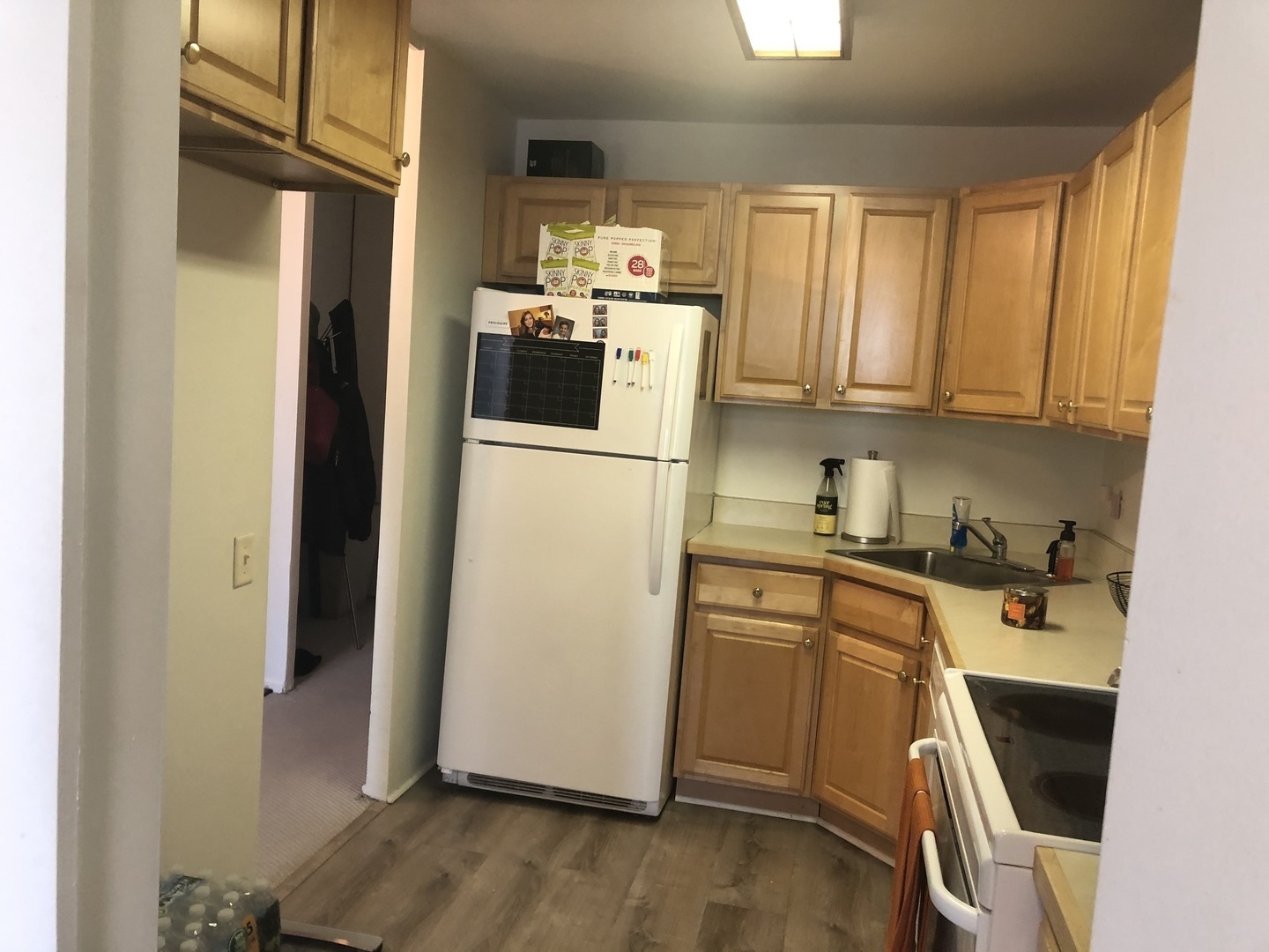 1030 North State Street, Unit 11G Chicago, IL 60610 - Photo 7 of 23 a kitchen with a refrigerator wooden floor and window