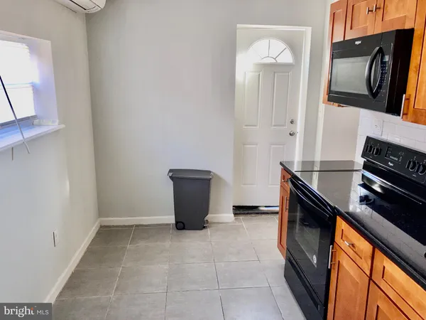 a kitchen with a refrigerator and cabinets