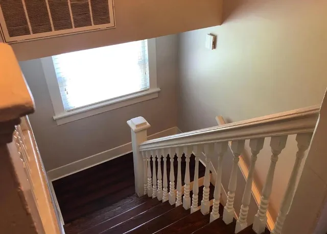 a view of entryway with wooden floor and stairs