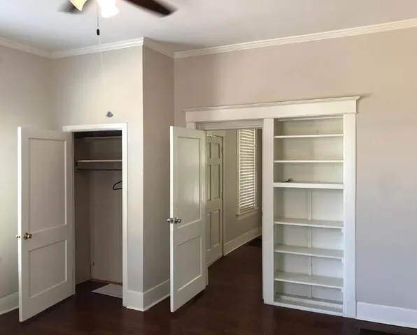 a view of walk in closet with empty racks