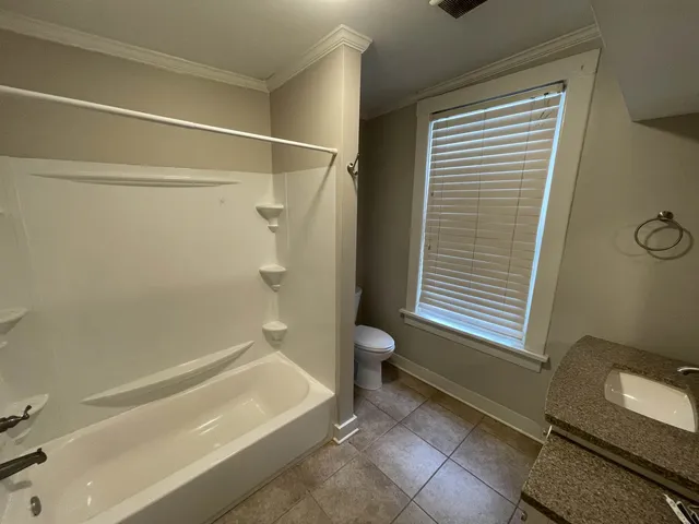 a bathroom with a window and a shower