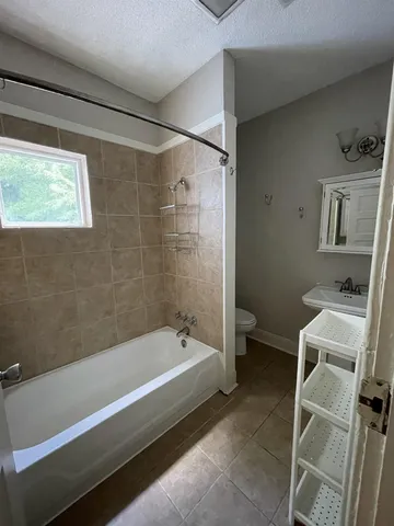 a bathroom with a bathtub and a toilet