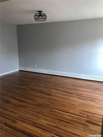 an empty room with wooden floor