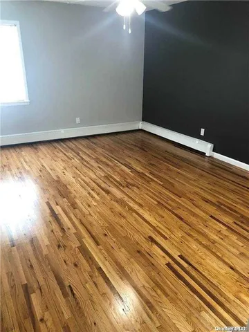 a view of room with wooden floor
