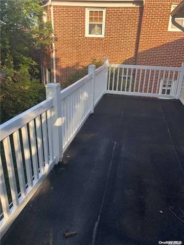 a view of balcony with wooden floor
