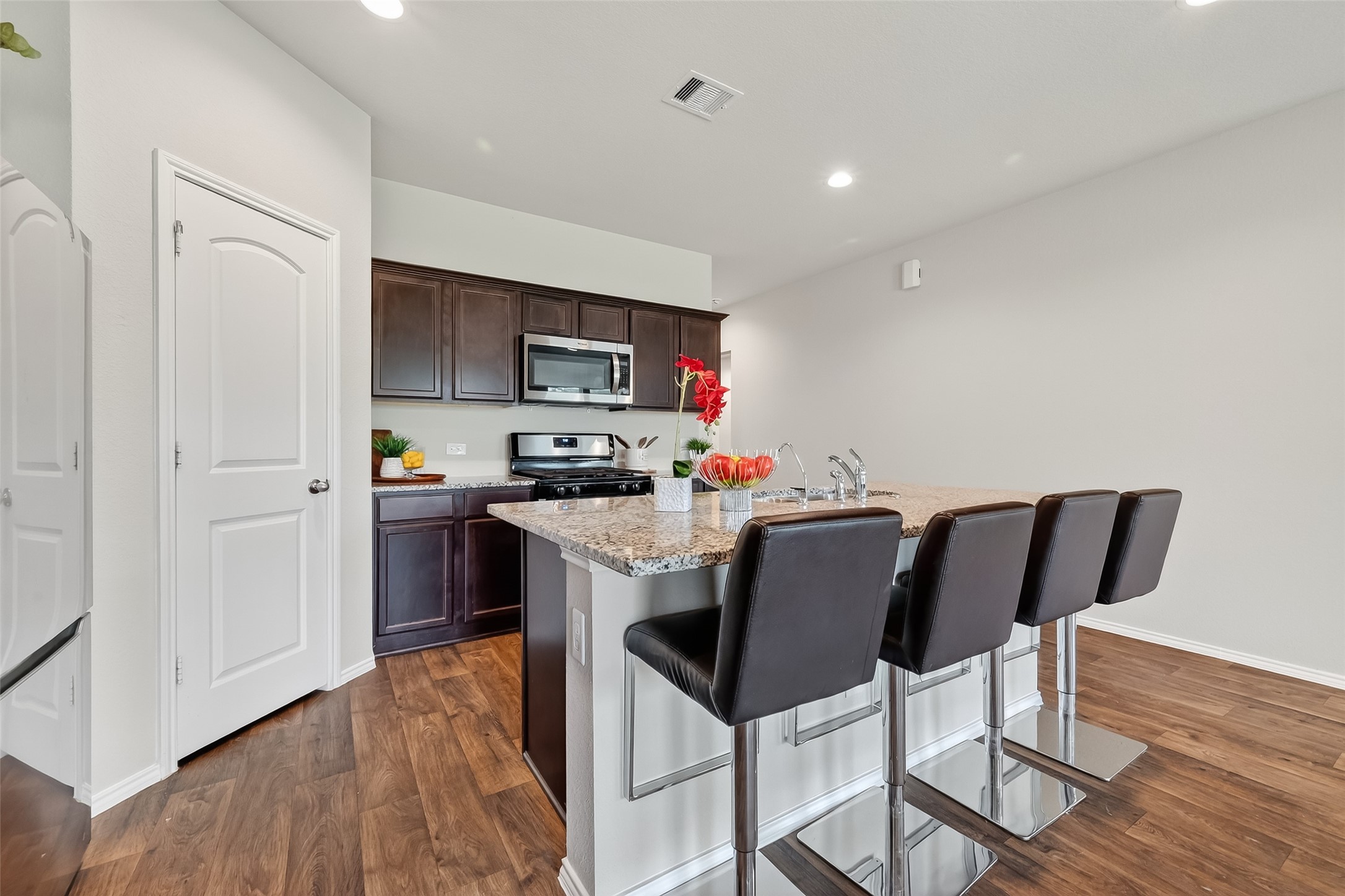 23511 Treeline Bluff Trail Spring Spring, TX 77373 - Photo 12 of 41 a kitchen with a table chairs refrigerator and microwave