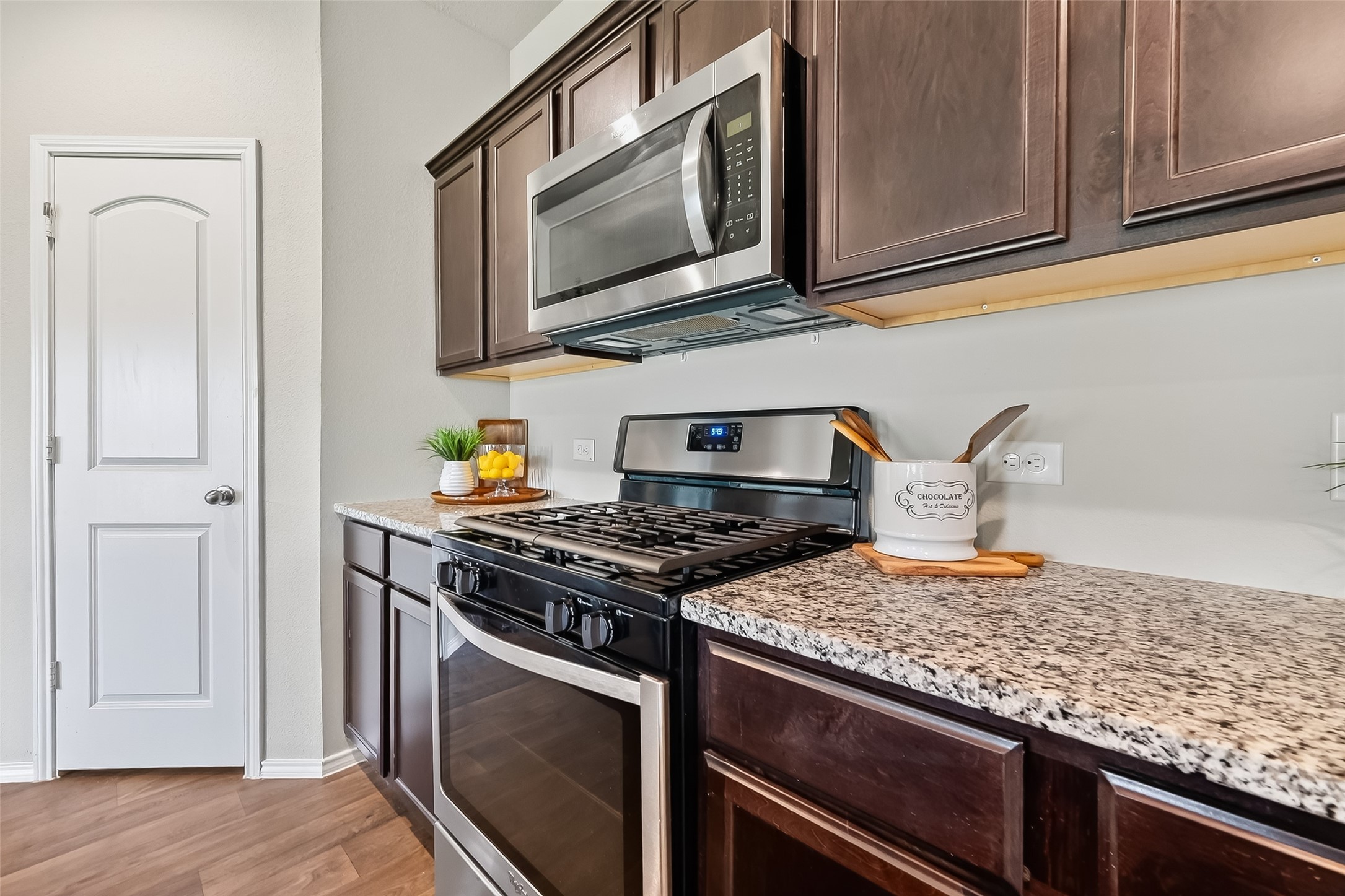 23511 Treeline Bluff Trail Spring Spring, TX 77373 - Photo 14 of 41 a kitchen with granite countertop cabinets stainless steel appliances and wooden floor