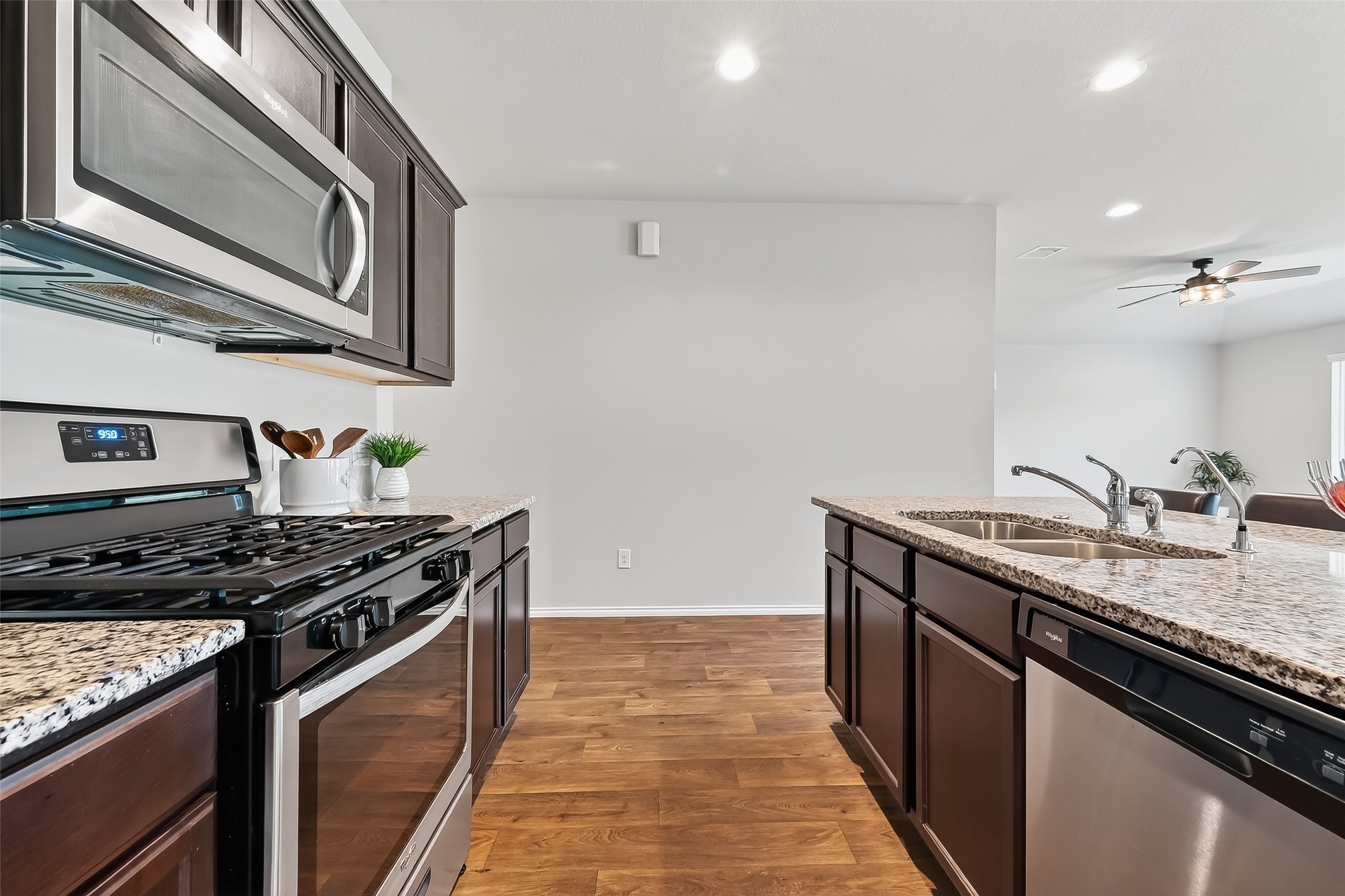 23511 Treeline Bluff Trail Spring Spring, TX 77373 - Photo 15 of 41 a kitchen with stainless steel appliances granite countertop a stove and a sink