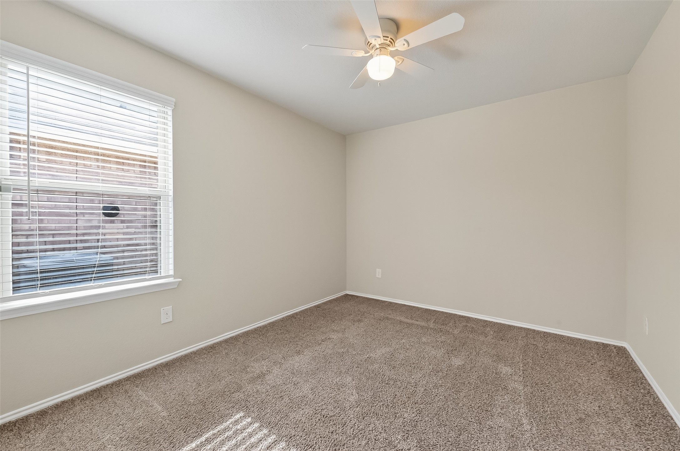 23511 Treeline Bluff Trail Spring Spring, TX 77373 - Photo 22 of 41 an empty room with a window and a fan