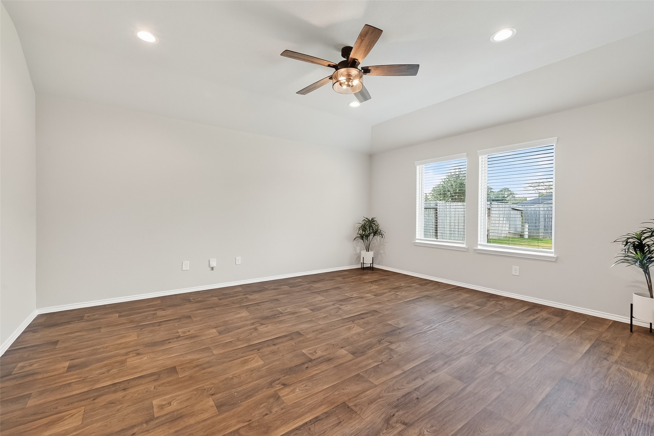 23511 Treeline Bluff Trail Spring Spring, TX 77373 - Photo 7 of 41 an empty room with wooden floor fan and windows