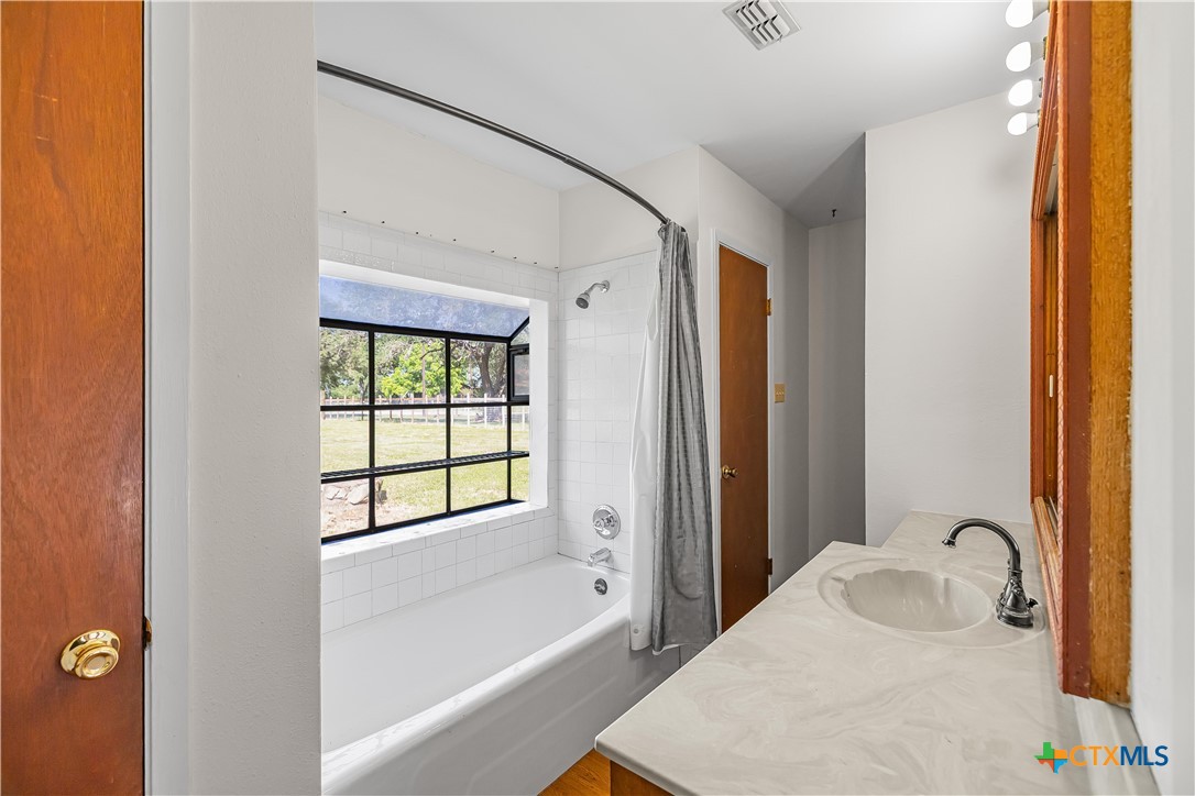 20 Hambleton Road Victoria, TX 77905 - Photo 24 of 48 a bathroom with a bathtub and a shower