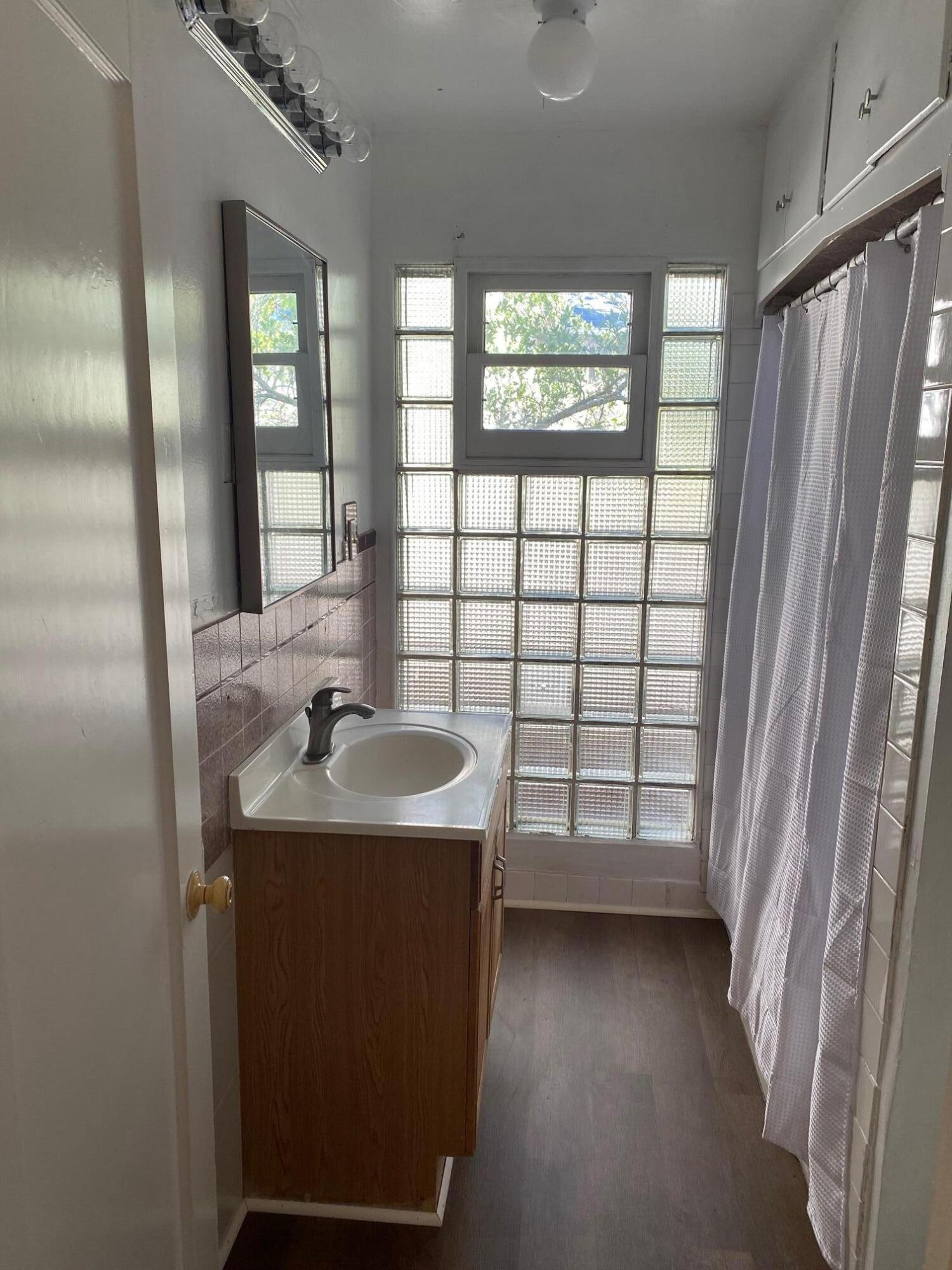 1410 Miller Way Red Bluff, CA 96080 - Photo 11 of 22 a bathroom with a sink a mirror and a shower