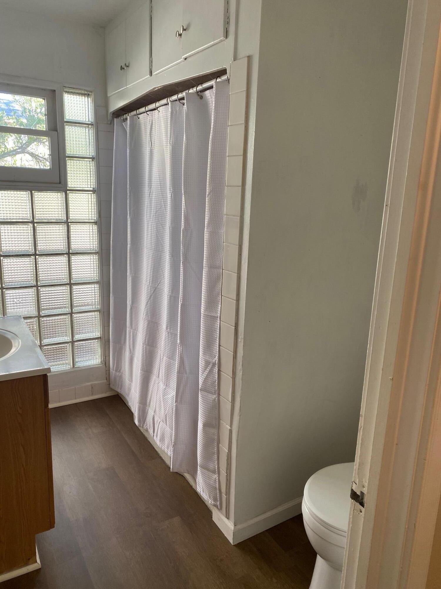 1410 Miller Way Red Bluff, CA 96080 - Photo 12 of 22 a bathroom with a toilet and a shower curtain