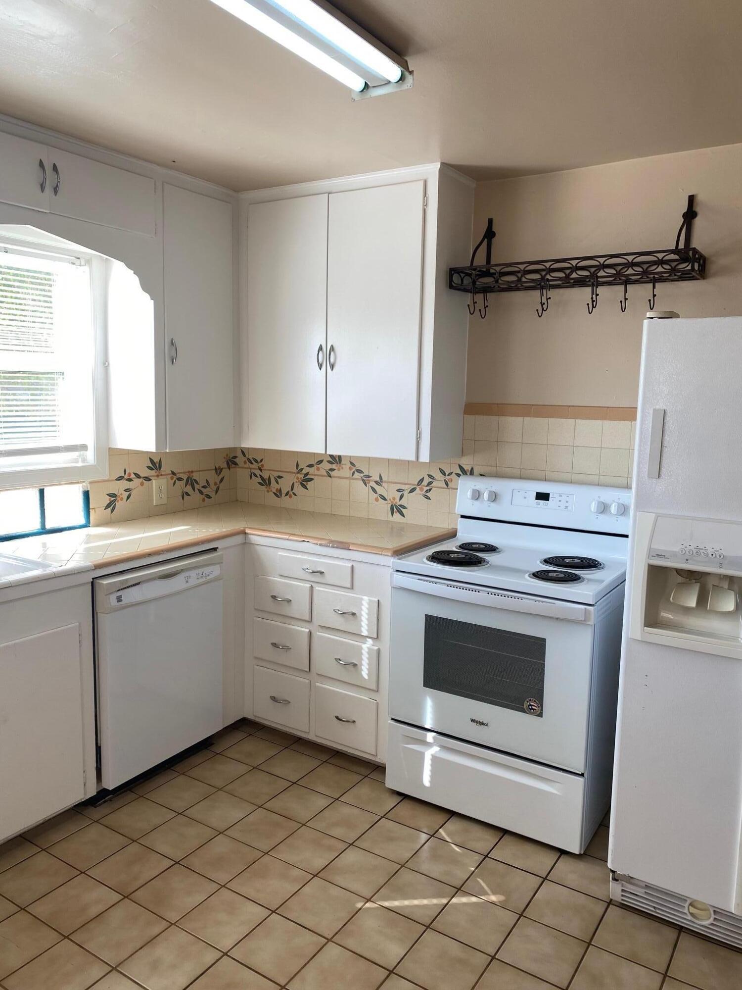 1410 Miller Way Red Bluff, CA 96080 - Photo 14 of 22 a kitchen with a stove sink and cabinets