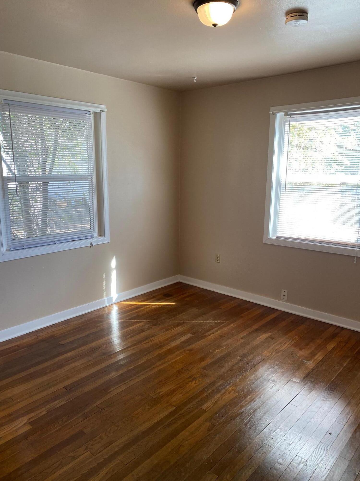 1410 Miller Way Red Bluff, CA 96080 - Photo 10 of 22 a view of an empty room with wooden floor and a window
