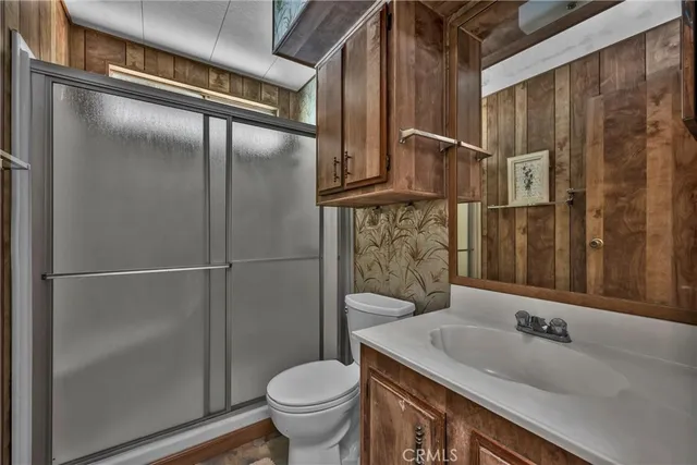 a living room with couches and a large window with wooden floor