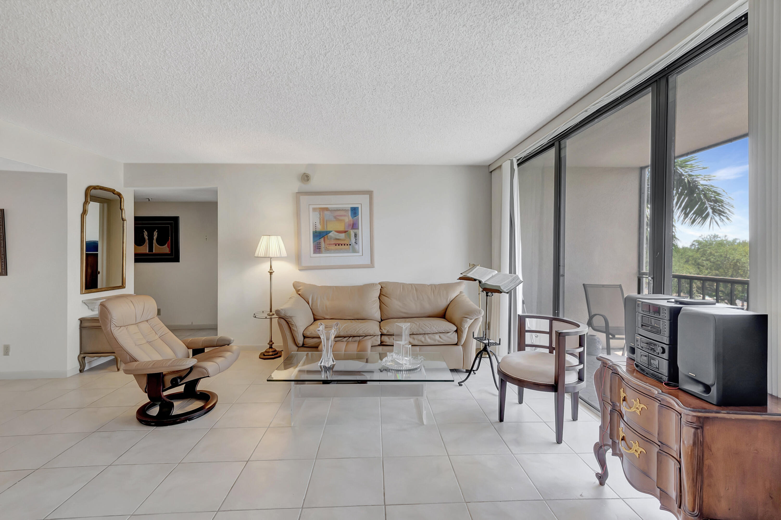 7738 Lakeside Boulevard, Unit 353 Boca Raton, FL 33434 - Photo 12 of 76 a living room with furniture and a flat screen tv