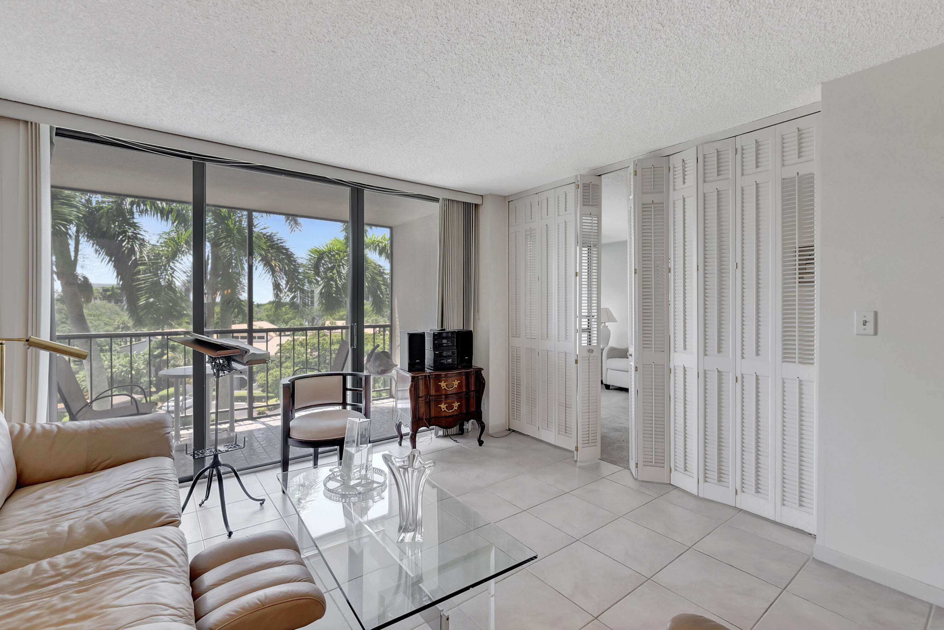 7738 Lakeside Boulevard, Unit 353 Boca Raton, FL 33434 - Photo 13 of 76 a living room with furniture and a floor to ceiling window