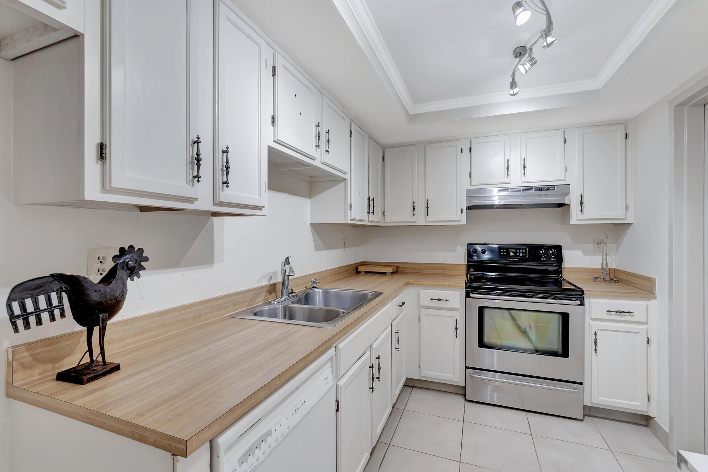 7738 Lakeside Boulevard, Unit 353 Boca Raton, FL 33434 - Photo 17 of 76 a kitchen with kitchen island granite countertop a sink stainless steel appliances and cabinets