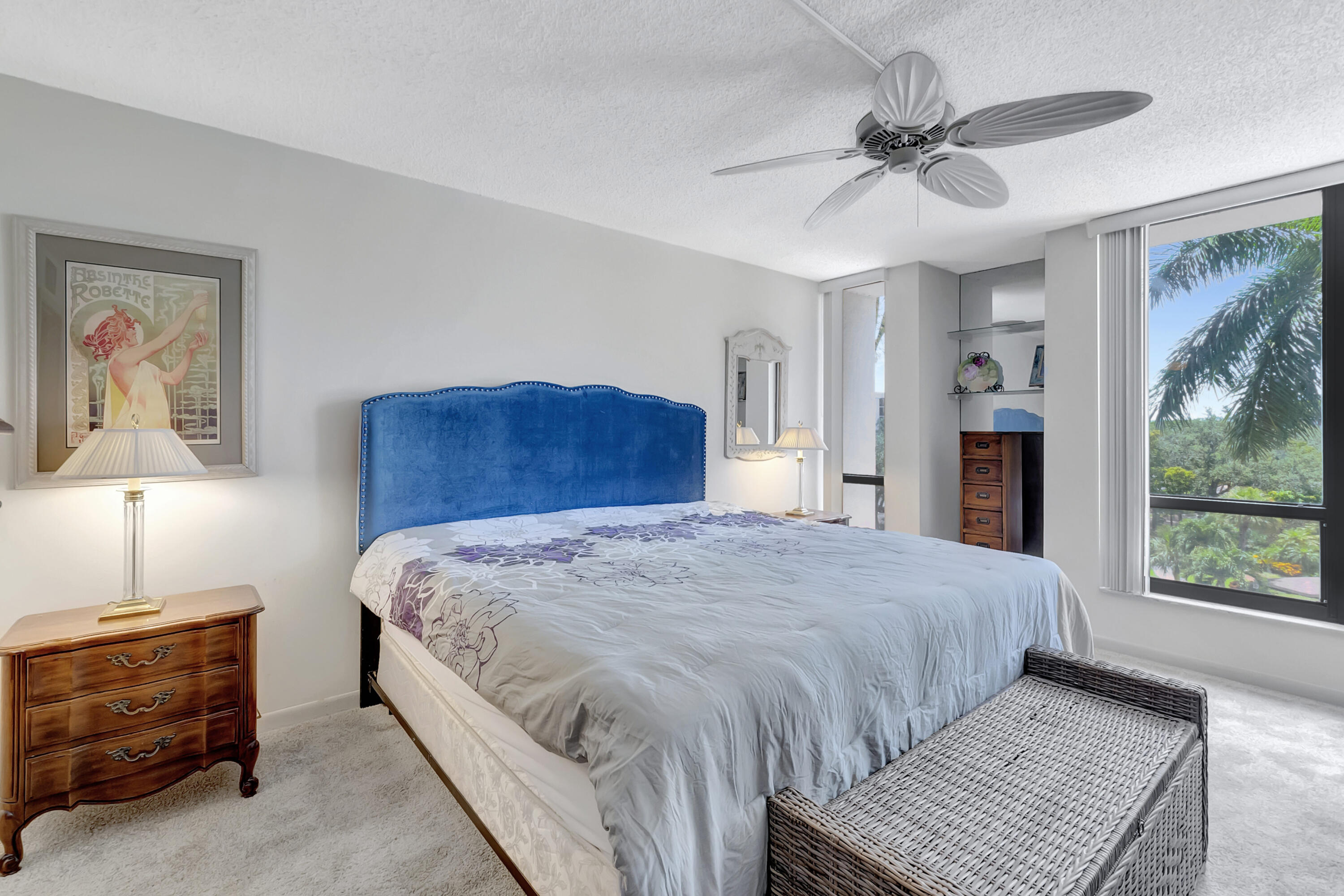 7738 Lakeside Boulevard, Unit 353 Boca Raton, FL 33434 - Photo 22 of 76 a bedroom with a large bed a chandelier and a window