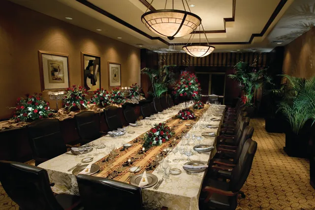 a living room with furniture a fireplace and chandelier