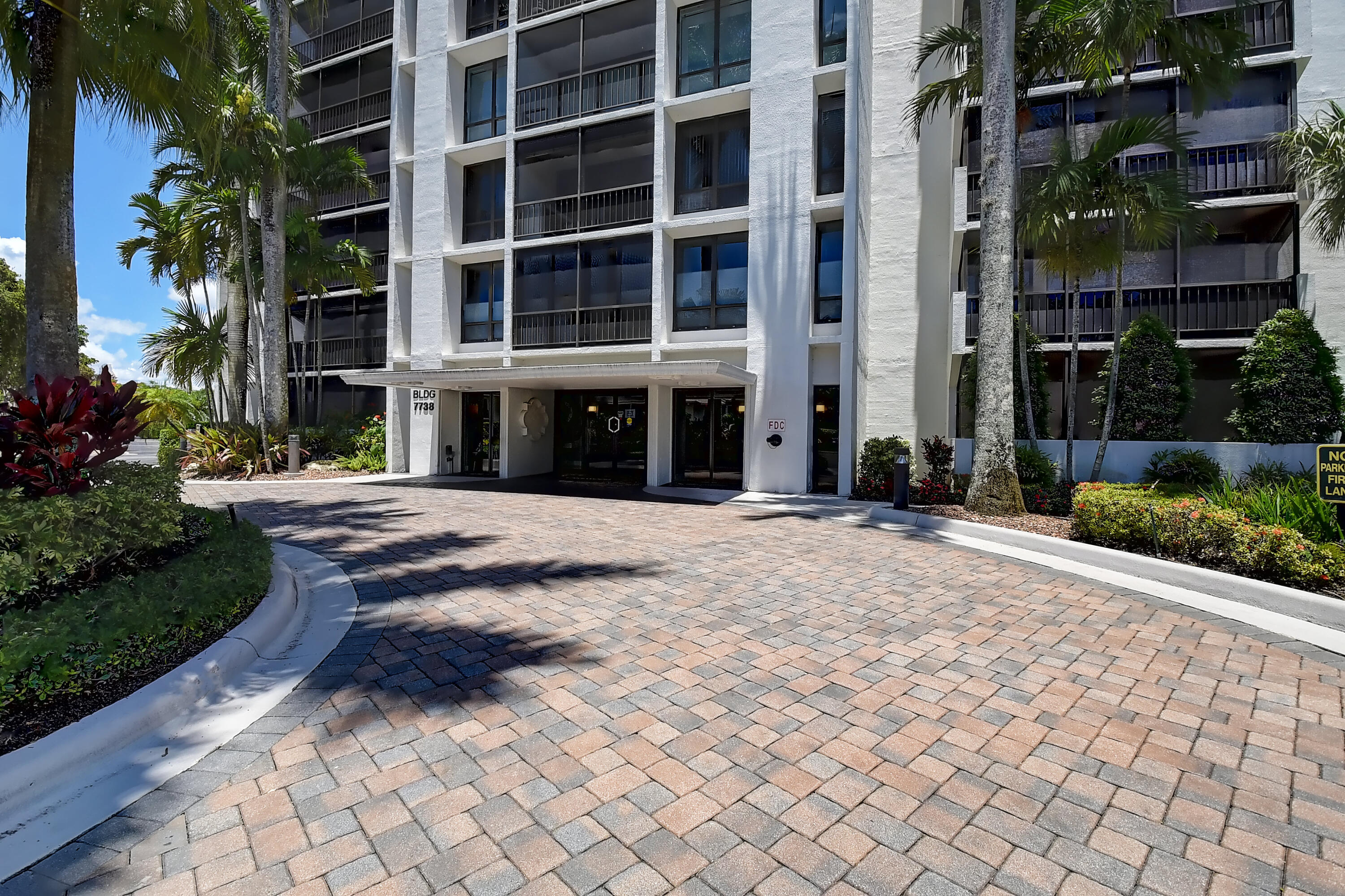 7738 Lakeside Boulevard, Unit 353 Boca Raton, FL 33434 - Photo 4 of 76 a front view of a building with a yard