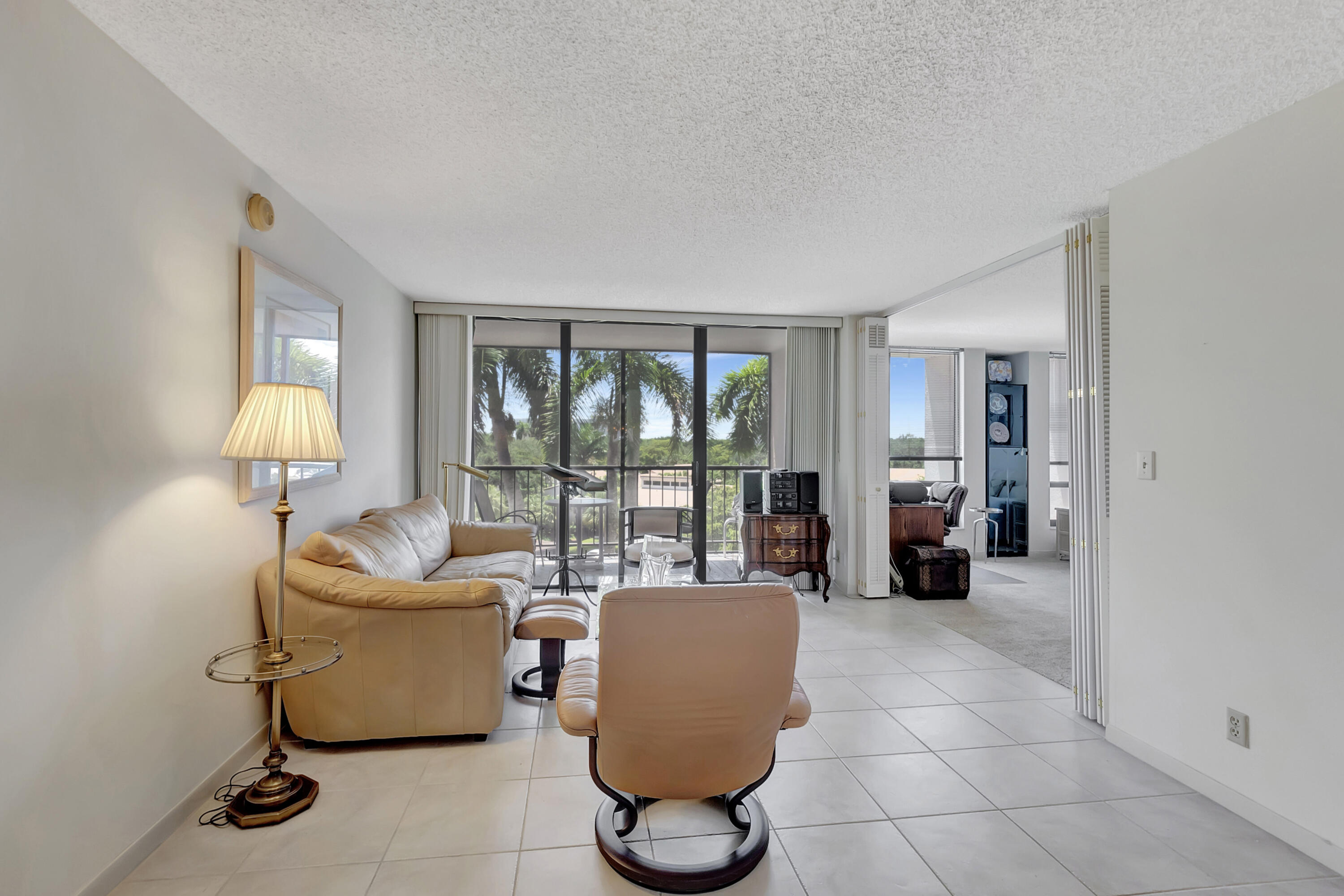 7738 Lakeside Boulevard, Unit 353 Boca Raton, FL 33434 - Photo 9 of 76 a living room with furniture and a floor to ceiling window