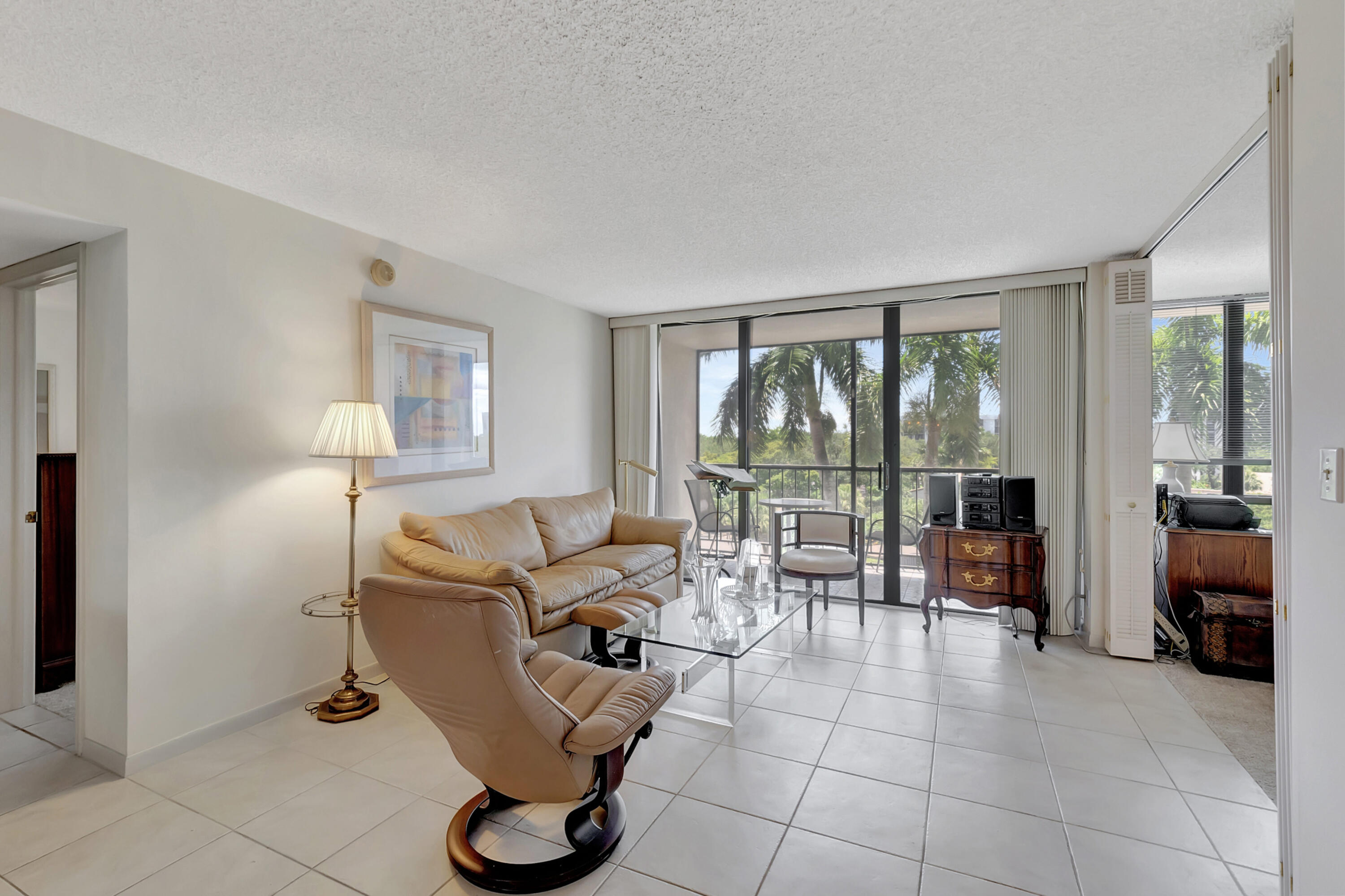 7738 Lakeside Boulevard, Unit 353 Boca Raton, FL 33434 - Photo 10 of 76 a living room with furniture and large windows