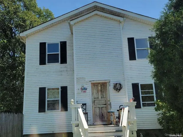 a front view of a house with stairs