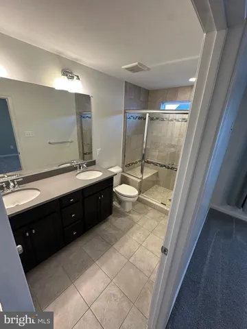a bathroom with a sink vanity mirror and toilet