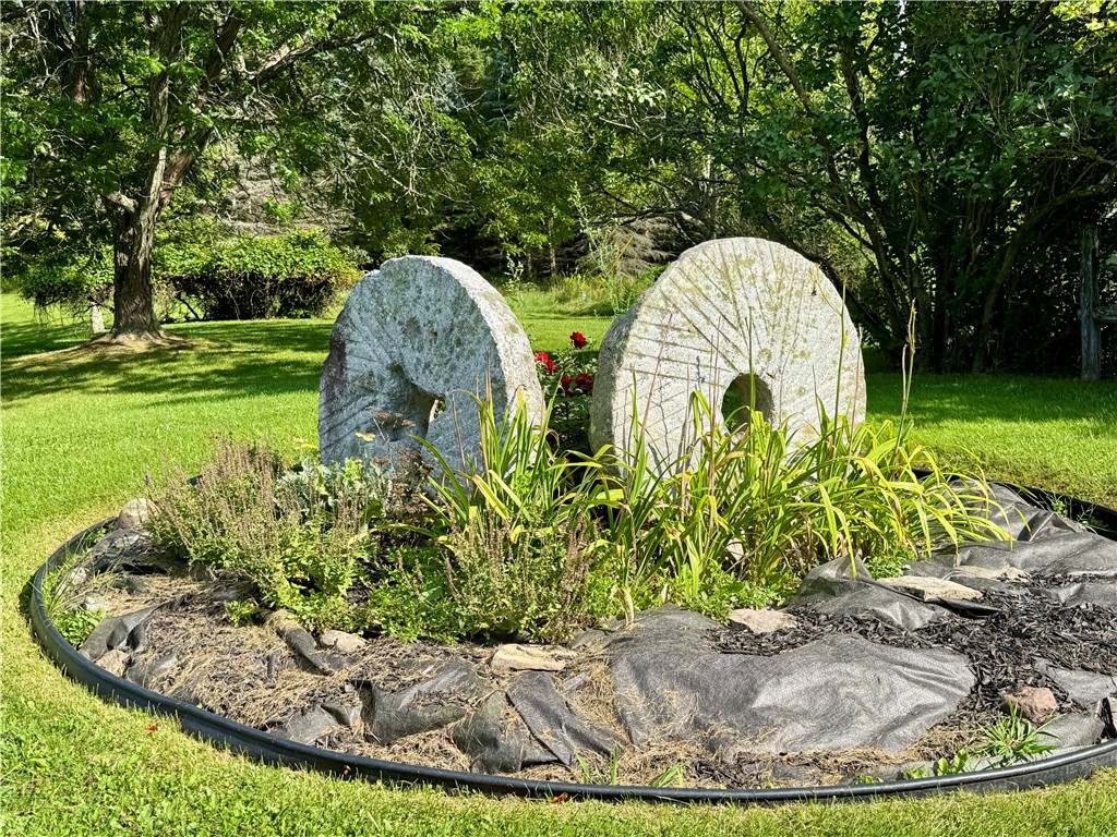 988 Swart Hollow Road Oneonta, NY 13820 - Photo 39 of 47 Millstones in one of the flowerbeds