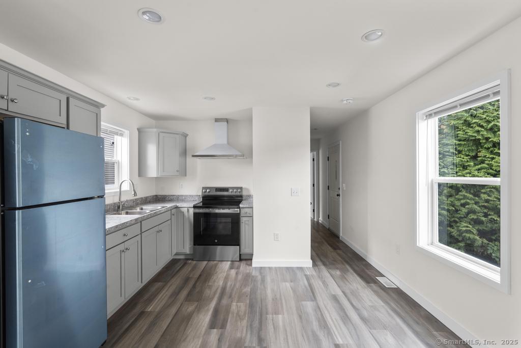 55 Sugar Street, Unit 4 Newtown, CT 06470 - Photo 4 of 22 a kitchen with granite countertop a refrigerator stove top oven and sink