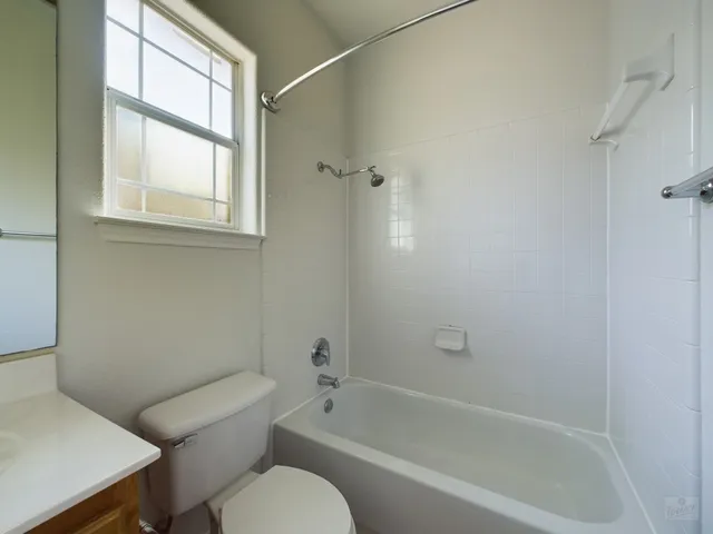 a white bath tub sitting next to a white toilet