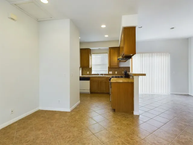a kitchen with a sink a counter top space stainless steel appliances and cabinets